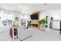 Bright living room featuring modern decor, a cozy fireplace, and large windows for ample natural light at 7828 Bright Lodge St, Las Vegas, NV 89139