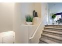 Carpeted staircase with white railing and a decorative display niche at 7935 Pandora Sky St # 381, North Las Vegas, NV 89084