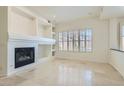 Spacious living room with tile flooring, a modern fireplace, and natural light at 8040 Arcadian Ln, Las Vegas, NV 89147