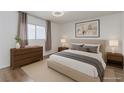 A bright bedroom features neutral walls and carpet, with contemporary furniture at 875 Rhinegold Way, Las Vegas, NV 89110