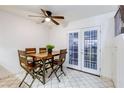 Cozy dining area features tiled floor and French doors that let in natural light, with seating for four at 875 Rhinegold Way, Las Vegas, NV 89110