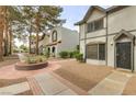 View of well maintained townhomes and landscape, showcasing a bright neighborhood at 875 Rhinegold Way, Las Vegas, NV 89110