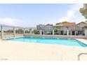 Community pool is surrounded by a fence and buildings, offering a private place to relax at 875 Rhinegold Way, Las Vegas, NV 89110