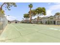 Tennis court surrounded by lush greenery, a perfect place to stay active at 875 Rhinegold Way, Las Vegas, NV 89110