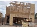 New home construction showing wooden framing, plywood sheathing, and open garage space at 9243 Charmillin Ct, Las Vegas, NV 89148