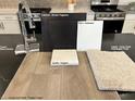 Interior finishes showcase wood-look flooring, carpet, granite, paint, cabinet, and faucet samples at 9243 Charmillin Ct, Las Vegas, NV 89148