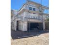 New construction home featuring a two-car garage and scaffolding, awaiting exterior finishing at 9249 Charmillin Ct, Las Vegas, NV 89148