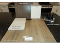 Display of kitchen and bathroom finish samples featuring cabinets, paint, quartz, vinyl plank and faucet at 9249 Charmillin Ct, Las Vegas, NV 89148