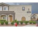 Stunning two-story condo featuring a cozy front porch, desert landscaping, and easy access to community amenities at 9303 Gilcrease Ave # 1002, Las Vegas, NV 89149