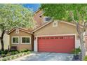 A cozy home with a two-car garage is enhanced by mature trees, lush landscaping, and a quaint bench at 9370 Corkfish St, Las Vegas, NV 89178