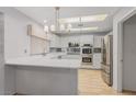 Beautiful kitchen features stainless steel appliances, an island counter, and bright lighting at 9917 Arbuckle Dr, Las Vegas, NV 89134