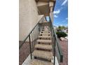 Exterior stairs leading to an apartment entrance, surrounded by desert landscaping and clear blue skies at 1320 Driscoll Dr # 202, Las Vegas, NV 89128