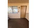 Inviting covered patio area with a front door and window providing natural light at 1320 Driscoll Dr # 202, Las Vegas, NV 89128