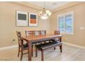 Well-lit dining room featuring a wooden table set, stylish lighting, and neutral wall color at 1405 Peyton Stewart Ct, North Las Vegas, NV 89086