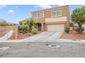 Charming exterior showcasing a two-story home with a spacious driveway and desert landscaping at 1405 Peyton Stewart Ct, North Las Vegas, NV 89086