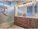 Modern bathroom featuring a double sink vanity with wood cabinets and a glass enclosed shower at 1510 Fieldbrook St, Henderson, NV 89052