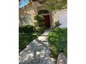 Stone walkway leading to the front door, flanked by manicured greenery, enhances curb appeal at 1782 Castro Hill Ave, Henderson, NV 89012