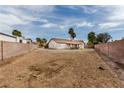 Large, empty backyard space enclosed by brick walls, ready for landscaping and outdoor living at 1816 Mazzanti Way, Henderson, NV 89014