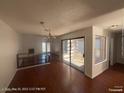 A bright living room featuring hardwood floors, fireplace, and natural light streaming through a window at 1850 Camino Verde Ln, Las Vegas, NV 89119