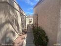 A quaint gated side entrance offers added privacy and charm to the property at 1850 Camino Verde Ln, Las Vegas, NV 89119