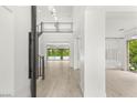 Bright foyer with wood floors, stairs, and clear views to the backyard oasis and pool at 2240 Boutique Ave, Henderson, NV 89044