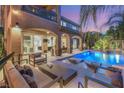Stunning backyard with a sparkling pool, comfortable lounge seating, and lush landscaping at 2240 Boutique Ave, Henderson, NV 89044