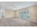 Bright, open living room featuring neutral tones, modern ceiling fan, and sliding glass doors at 2706 Colanthe Ave, Las Vegas, NV 89102