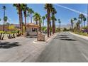 A view of the information center for the Sun City community with towering palms and mountain views at 2805 Hanging Rock Dr, Las Vegas, NV 89134