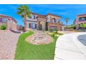 Beautifully landscaped front yard with a rock feature and lush green lawn leading to the inviting home at 2820 Sisteron Ct, Henderson, NV 89044