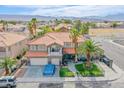Beautiful aerial view of the home featuring a red tile roof, palm trees, and landscaping at 3617 Dutch Valley Dr, Las Vegas, NV 89147