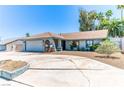 Charming single-story home featuring a two-car garage, desert landscaping, and a welcoming front entrance at 4381 Toledo Ave, Las Vegas, NV 89121