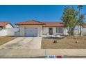 Charming single-story home featuring a tile roof, two car garage, and desert landscaping at 445 Concord Way, Henderson, NV 89015