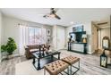 Cozy living room with wood floors, large window, modern decor, and stylish furniture at 445 Concord Way, Henderson, NV 89015