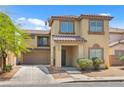 Two-story home featuring a well-maintained front yard and attached two-car garage at 4858 Longshot Dr, Las Vegas, NV 89122