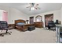Spacious main bedroom with ceiling fan, carpet, and plenty of natural light at 4858 Longshot Dr, Las Vegas, NV 89122