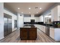 Spacious kitchen boasts granite countertops, stainless steel appliances, and a large center island at 5210 Villa Dante Ave, Las Vegas, NV 89141