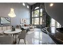 Bright and airy living room featuring soaring ceilings, large windows, and stylish modern decor at 5210 Villa Dante Ave, Las Vegas, NV 89141