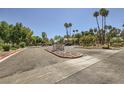Well-maintained community entrance with lush landscaping, mature trees, and clear signage at 5241 Caspian Springs Dr # 203, Las Vegas, NV 89120