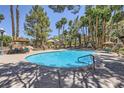 Inviting community pool with shaded seating areas and well-manicured landscaping at 5241 Caspian Springs Dr # 203, Las Vegas, NV 89120