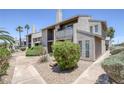 Condo exterior with desert landscaping and mature palm trees at 526 Sellers Pl, Henderson, NV 89011