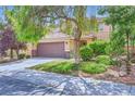Two-story home with a two-car garage and a charming, well-maintained front yard at 529 Caribbean Palm Dr, Las Vegas, NV 89138