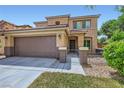 Inviting two-story home featuring a well-kept lawn, covered entrance, and two-car garage at 529 Caribbean Palm Dr, Las Vegas, NV 89138
