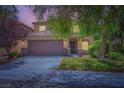 Charming two-story home featuring a well-manicured lawn, covered entrance, and a two-car garage at 529 Caribbean Palm Dr, Las Vegas, NV 89138