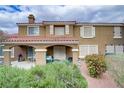 Charming two-story home showcasing a beautiful exterior with a tiled roof and well-maintained landscaping at 5465 Cardinal Ridge Ct # 103, Las Vegas, NV 89149