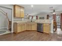 Open-concept kitchen featuring wooden cabinetry, stainless steel appliances, and an adjacent dining area at 5465 Cardinal Ridge Ct # 103, Las Vegas, NV 89149