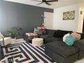 Spacious living room featuring a large sectional sofa, stylish rug, and trendy decorations at 5576 W Rochelle Ave # 13A, Las Vegas, NV 89103