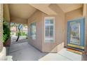 Inviting front porch with tiled flooring, large windows, and a beautiful blue front door at 5931 Allanche Ave, Las Vegas, NV 89141