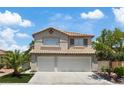 Charming two-story home featuring a three-car garage, desert landscaping, and a tile roof at 600 Beresford Ave, Las Vegas, NV 89123