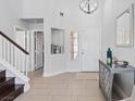 Bright foyer featuring tile flooring, staircase, and stylish decorative accents, creating a welcoming entrance at 600 Beresford Ave, Las Vegas, NV 89123