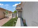 Inviting front entrance with a walkway and charming landscaping, enhancing curb appeal at 600 Beresford Ave, Las Vegas, NV 89123